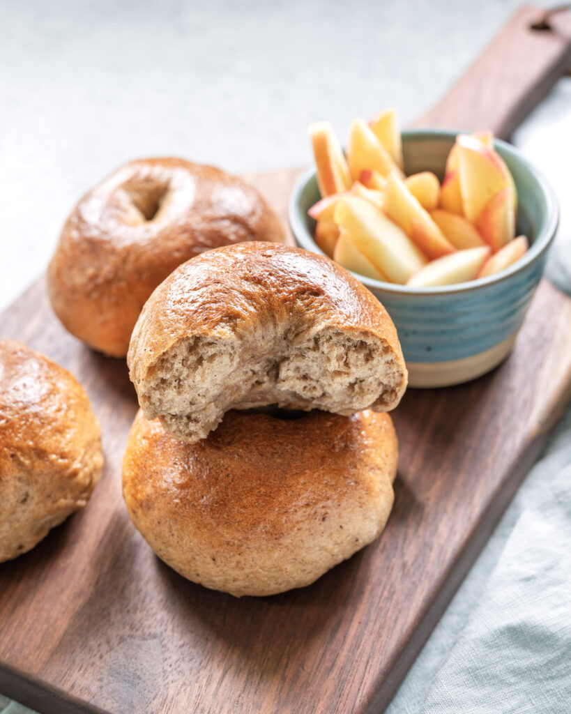 Apple butter sourdough beer bagel sliced in half to show the inside texture.