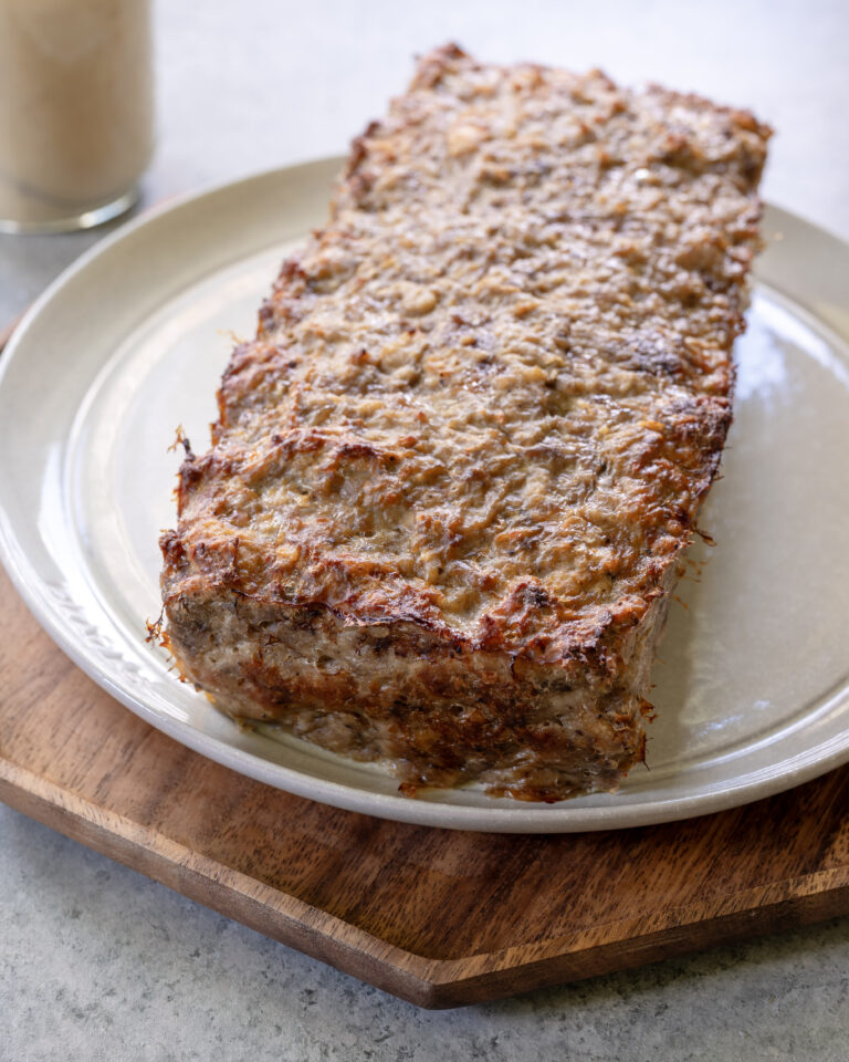 Full cooked meatloaf on a plate.